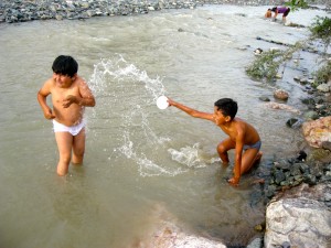 <p>Boys splashing around in a river in Nasca, Peru. Photo by Caitlin Smith.</p>
