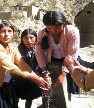 <p>Women and girls washing hands in Bolivia</p>
