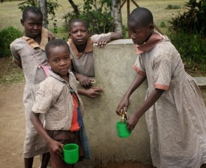 <p>School kids with getting water with cups. Photo by Matt Freeman</p>
