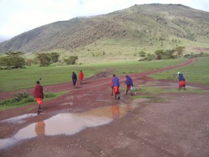 <p>The Maasai people walking near stagnant waters following the rainy season in Mtu Wa Mbu, Tanzania.  Photo by Melia Haile.</p>
